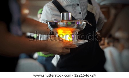 Serving the hot pot.