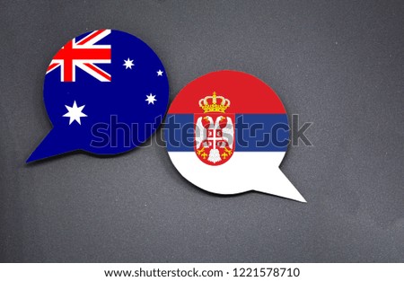 Australia and Serbia flags with two speech bubbles on dark gray background