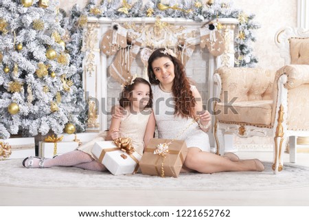 Portrait of happy mother with cute little daughter posing