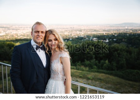 Wedding couple stand on the background of the city
