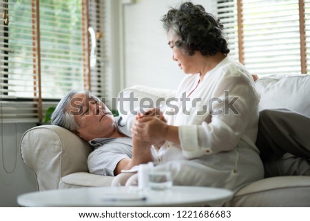 Asian Senior Couple holding hands together. Disease, illness, Comforting.