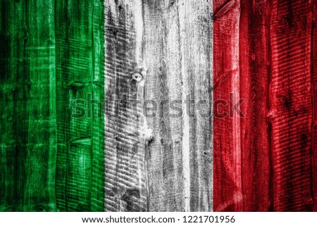 National flag of Italy on a textured wooden background, fence or wall