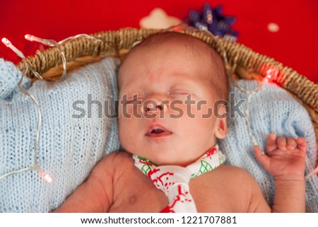 Christmas portrait of cute little newborn baby boy in basket