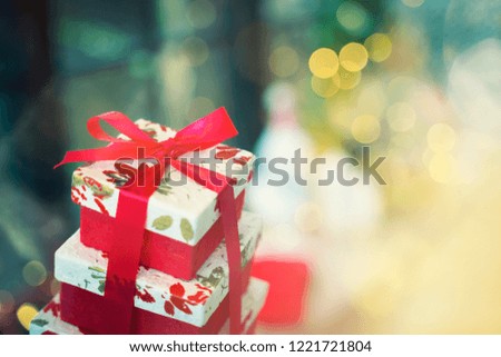 Gift box with bokeh blurred lighting background. Can use as Merry Christmas party, Happy New Year or Happy birthday background.