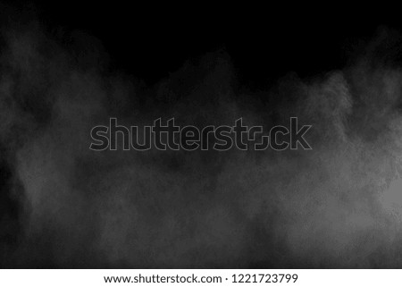 Bizarre forms of white powder explosion cloud against black background.White smoke particles splash.