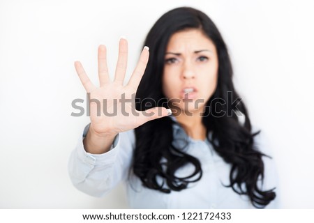 Serious woman making stop hand sign palm gesture, young girl focus on foreground