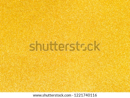 decorative paper with glitter, goods for creativity. golden shiny background.