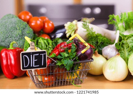 Shopping basket with diet sign and many colorful vegetables. Healthy eating lifestyle, vegetarian food.