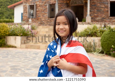 Cute Little asian girl and American flag Backyard in home