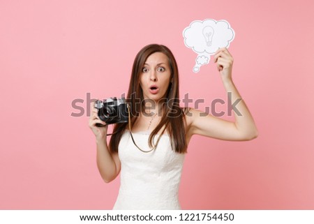 Shocked bride woman in wedding dress hold retro vintage photo camera, Say cloud speech bubble with lightbulb choosing staff, photographer isolated on pink background. Organization, Wedding to do list