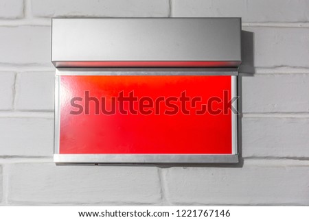 Copy space on red display on white brick wall as mock up or blank for design, close up
