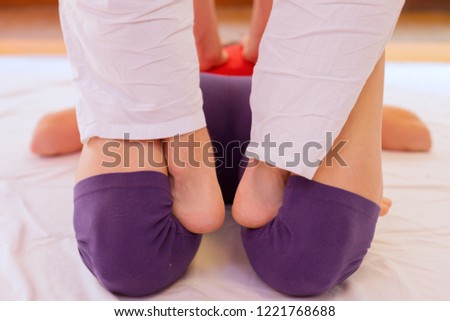 Horizontal Close up of barefoot Shiatsu massage on the back of legs and feet.