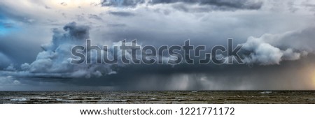 Picture of storm with dramatic clouds at the sea.