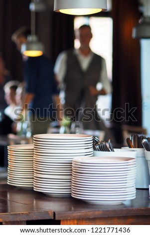 Picture of cafe interior with plates and coffee mugs.
