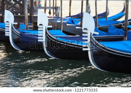 Gondola boats moored in Grand Canal in the early morning in Venice, Italy