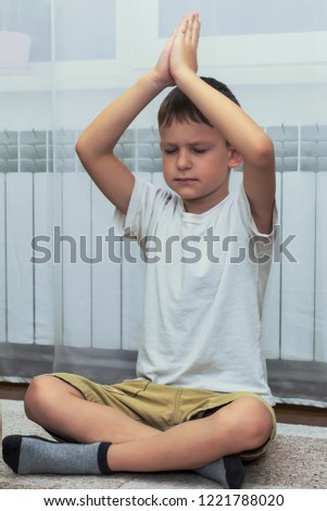 little boy meditating at home