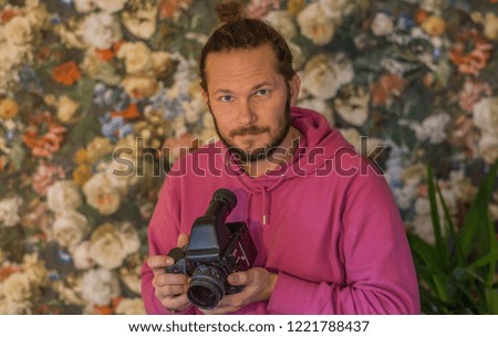 Self portrait of the photographer holding a medium format camera