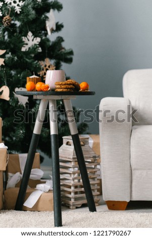 Girl cleans tangerines near the Christmas tree