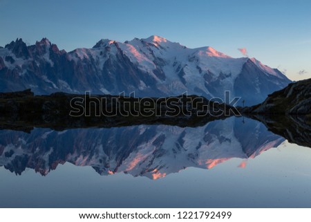 The Mont Blanc massif reflected in Lac de Chesery during dusk. Chamonix, France.