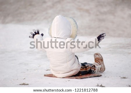A child on a snow sled