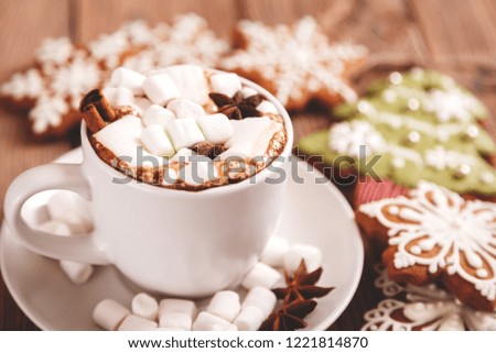 Christmas or New year background. A Cup of festive hot chocolate or cocoa with marshmallows and traditional gingerbread cookies on the table. The concept of advertising of cocoa. Christmas still life
