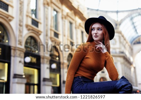 Woman pose for a portrait outside of the Galleria Vittorio Emanuele II in Milano Italy