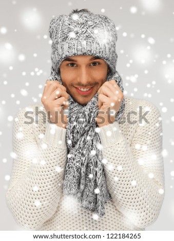 picture of handsome man in warm sweater, hat and scarf.