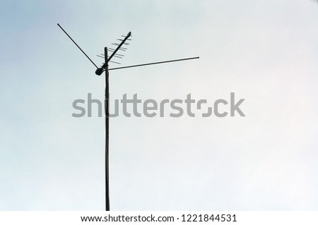 TV antenna on a long mast against the sky
