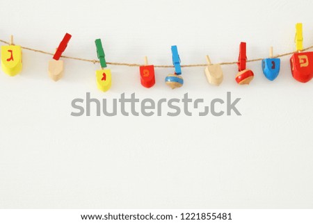 Image of jewish holiday Hanukkah with wooden dreidels colection (spinning top) over white background