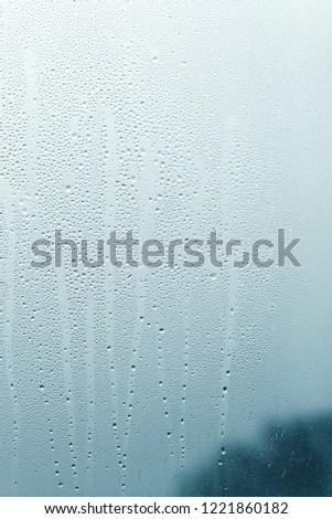 Rainy day from the window, close-up of raindrops on glass 