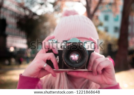 Girl woman holding 35mm retro photography camera