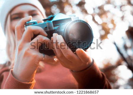 Girl woman holding 35mm retro photography camera