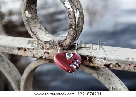 Red heart shaped padlock at love bridge. 