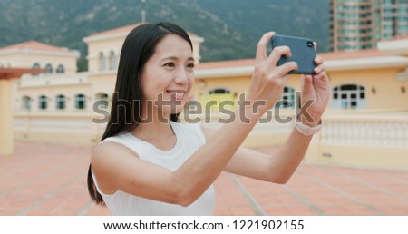 Woman taking photo on cellphone