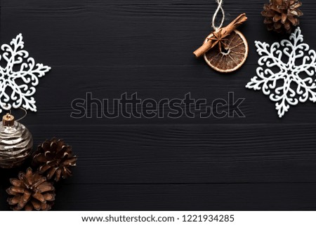 Christmas background. Christmas toys on a black wooden background