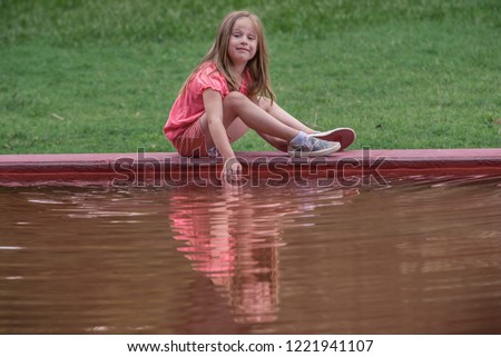 A 5 year old child and her reflection in fountain