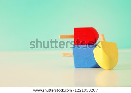 Image of jewish holiday Hanukkah with wooden dreidels colection (spinning top).