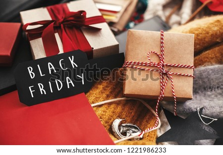 Black Friday big sale text sign. Special discount christmas offer. Advertising message at gift boxes, price tags, credit cards, money, bags, wallet on rustic background. Christmas shopping