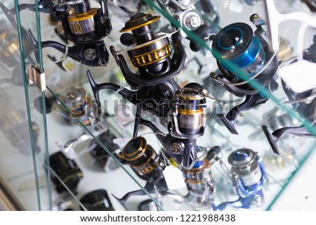 Close-up photo of variety baitcasting reel in the fishing store