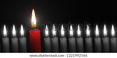 business concept best idea red candle among other candles black background close-up