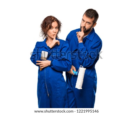 Painters showing a sign of closing mouth and silence gesture on isolated white background