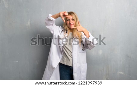 Young doctor woman focusing face. Framing symbol
