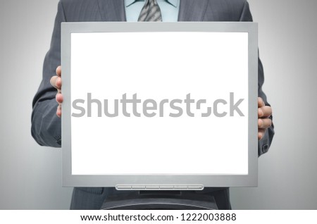 TV computer monitor with blank screen in the businessman hand isolated on white background.
