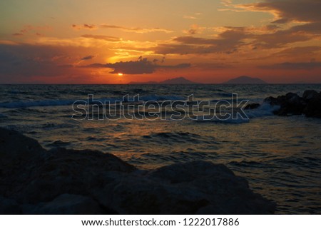 Artistic view of romantic sunset orange red sky and dark sea. Beautiful orange yellow sky. High resolution artistic skyline background image
