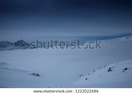 Fog below mountain peaks in winter