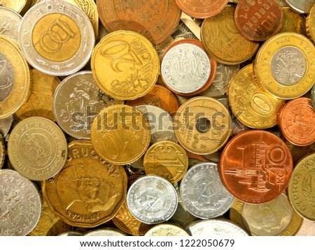 Close up top view image of large amount of old money coins of different countries and times on dollars usa background