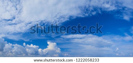 Wide panoramic view of romantic navy blue sky with white grey clouds. High resolution artistic skyline background image. Sky panorama. Freedom flight concept