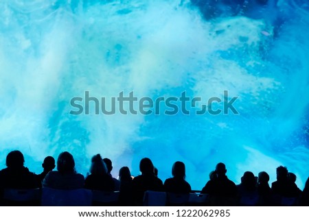 People looks to the big blue projection of space at modern planetarium Royalty-Free Stock Photo #1222062985