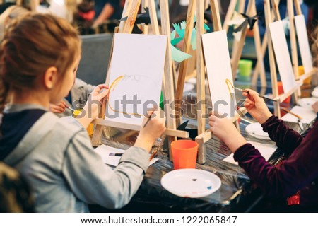 group lesson in drawing. Children learn to draw in the classroom. Royalty-Free Stock Photo #1222065847