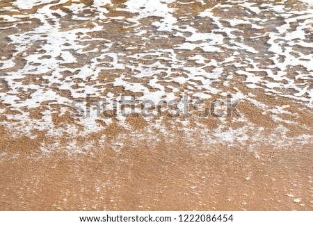 Surf. Close-up of a sea foam and sandy coast